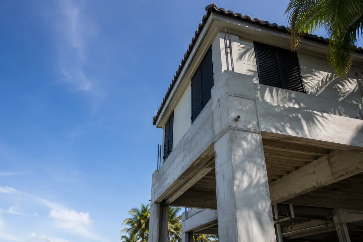 Elevated South Florida home with impact shutters, showing residential structural engineer florida expertise.